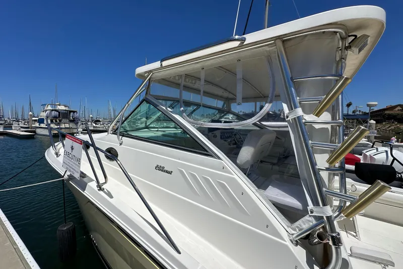 Slide: The Image of 2003 Wellcraft 330 Coastal boat docked at marina under clear blue sky. - 3
