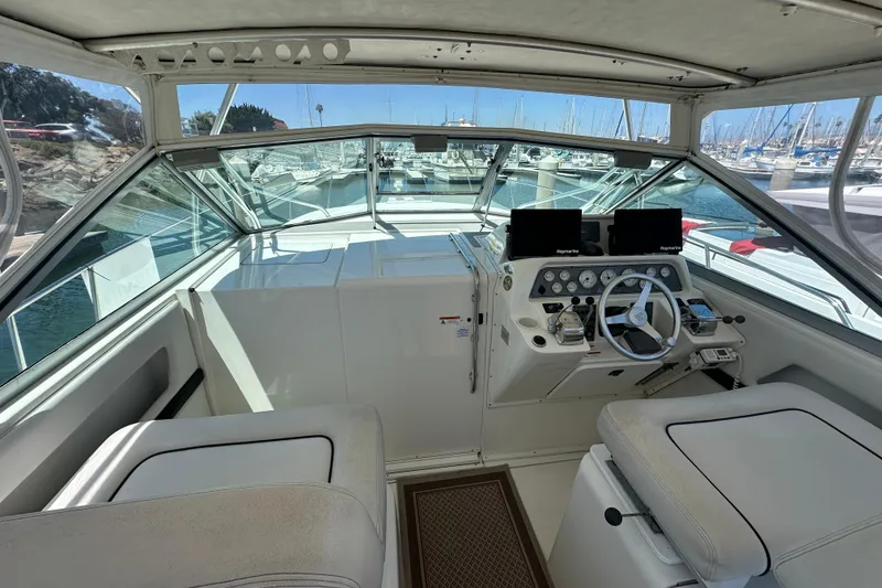 Slide: The Image of 2003 Wellcraft 330 Coastal boat cockpit with steering wheel and navigation equipment. - 7