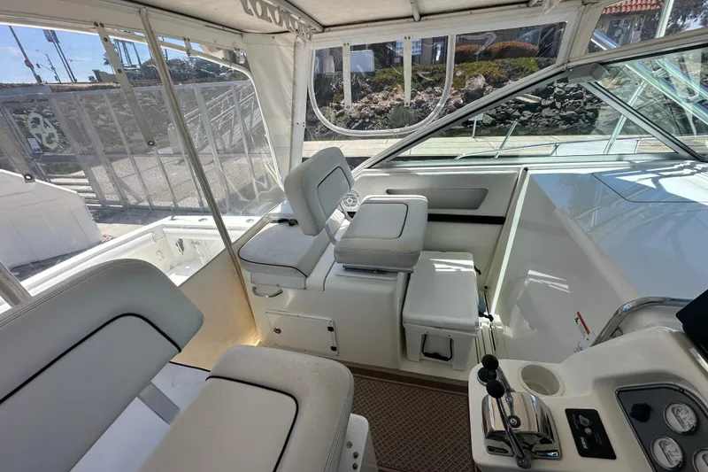 Slide: The Image of 2003 Wellcraft 330 Coastal boat interior with helm and seating area. - 8
