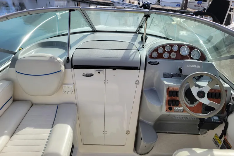 Slide: The Image of 2007 Bayliner 245 Cruiser cockpit with steering wheel, gauges, and seating. - 10