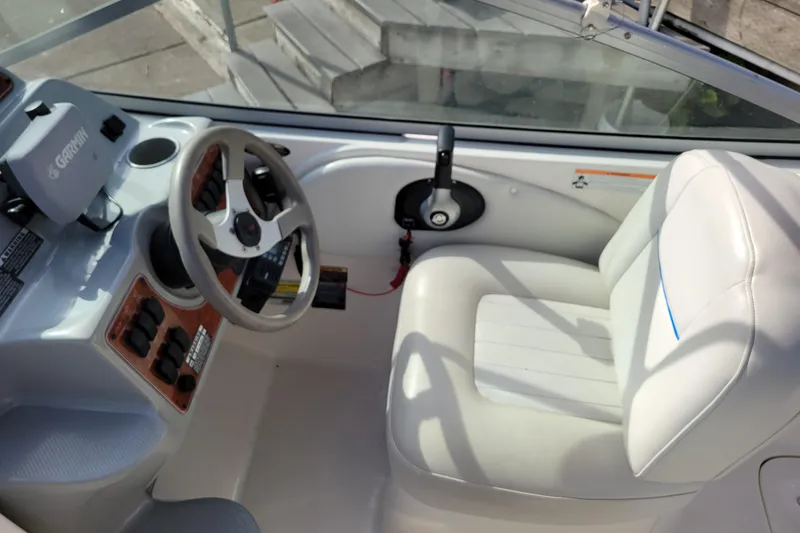 Slide: The Image of 2007 Bayliner 245 Cruiser helm with steering wheel and Garmin navigation system. - 11