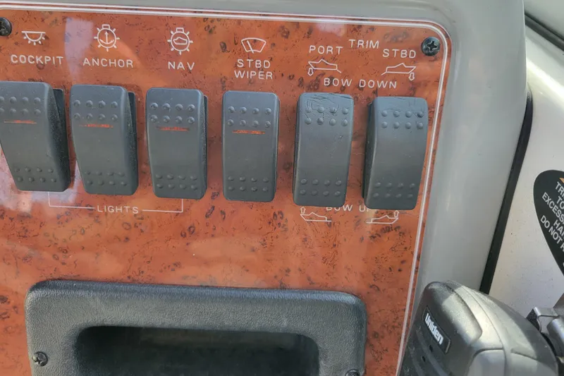 Slide: The Image of Control panel of a 2007 Bayliner 245 Cruiser with labeled switches. - 14