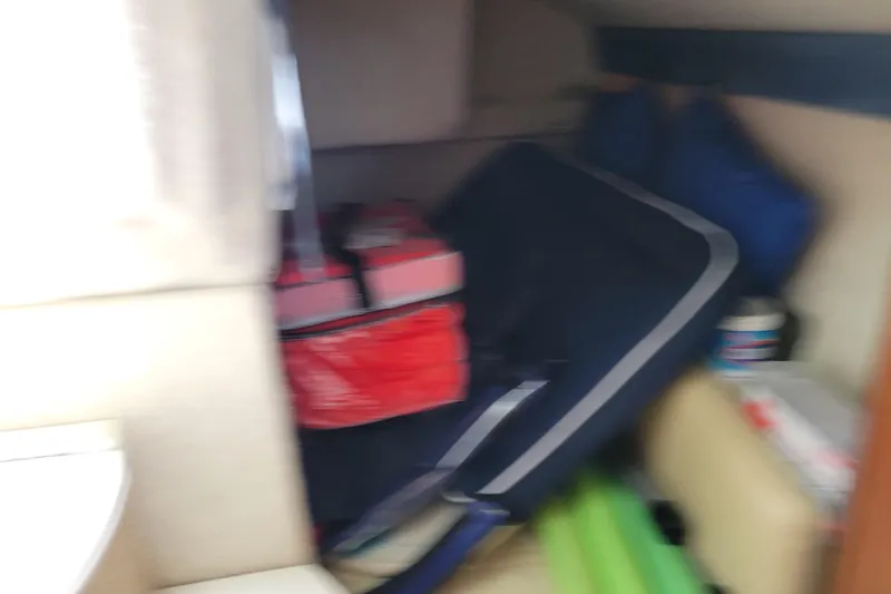 Slide: The Image of Interior of a 2007 Bayliner 245 Cruiser with stored items and equipment. - 27