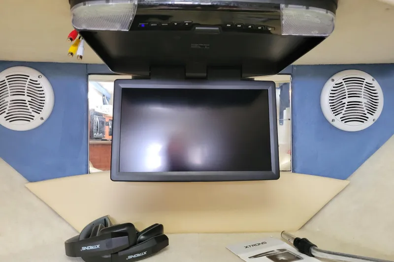 Slide: The Image of 2007 Bayliner 245 Cruiser interior with screen, speakers, and XTRONS accessories. - 28