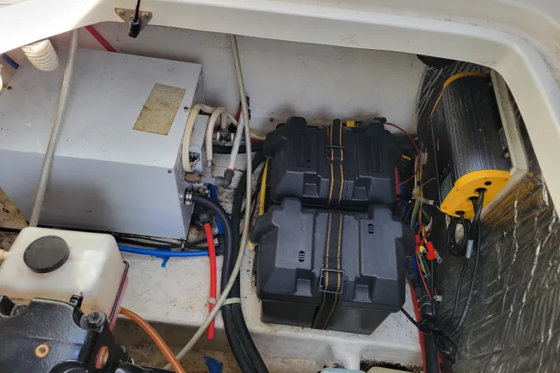 Slide: The Image of 2007 Bayliner 245 Cruiser engine compartment with batteries and electrical components. - 30