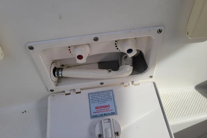 Slide: The Image of 2007 Bayliner 245 Cruiser shower controls with hot and cold water knobs. - 33