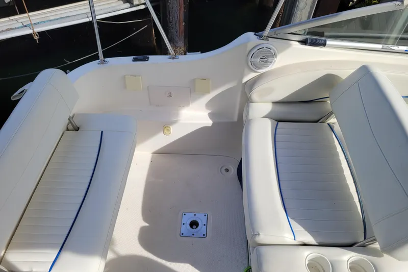Slide: The Image of 2007 Bayliner 245 Cruiser interior with white seating and cup holders. - 9