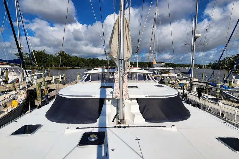 Slide: The Image of 2007 Antares Catamarans PDQ 44i docked at marina under blue sky. - 10