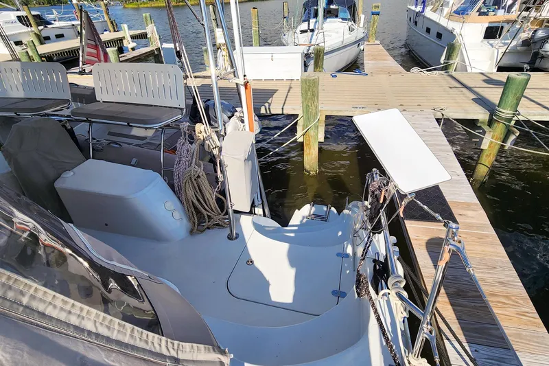 Slide: The Image of 2007 Antares Catamarans PDQ 44i docked at marina, featuring spacious deck and seating area. - 16