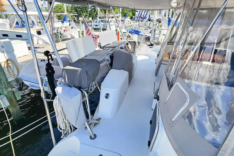Slide: The Image of 2007 Antares Catamarans PDQ 44i docked, featuring spacious deck and covered seating area. - 17