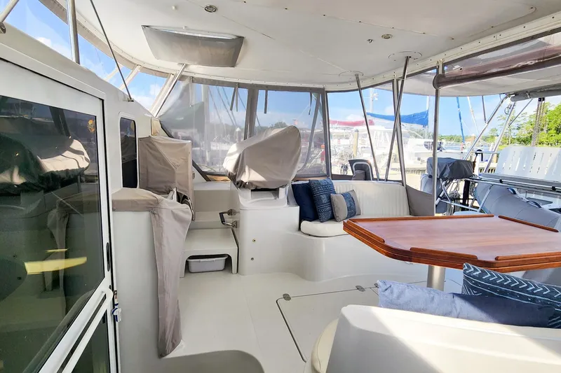 Slide: The Image of 2007 Antares Catamarans PDQ 44i interior with seating and wooden table. - 19