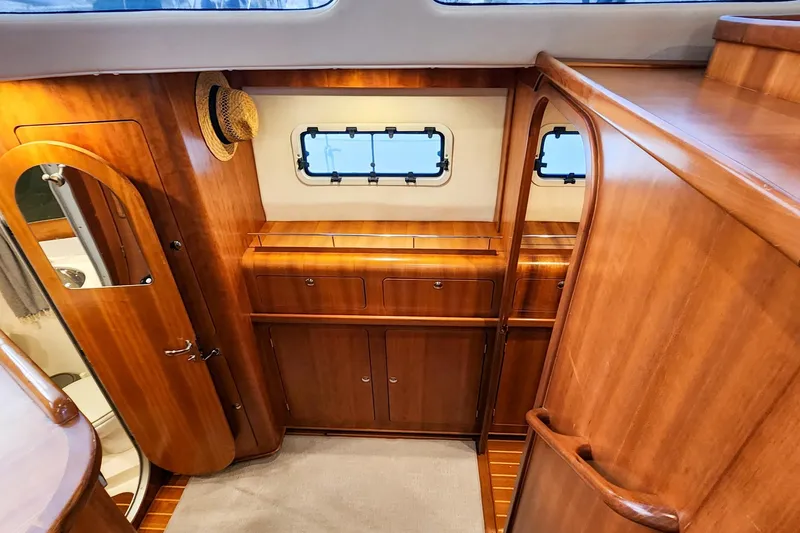 Slide: The Image of Luxurious wooden interior of 2007 Antares Catamarans PDQ 44i, featuring cabinets and a small window. - 27
