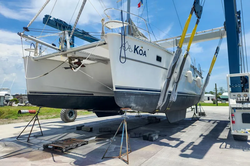Slide: The Image of 2007 Antares Catamarans PDQ 44i on lift, undergoing maintenance at a marina. - 3
