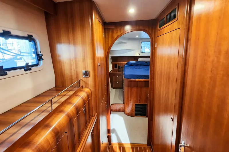 Slide: The Image of Interior of 2007 Antares Catamarans PDQ 44i, featuring wood paneling and cozy cabin space. - 30