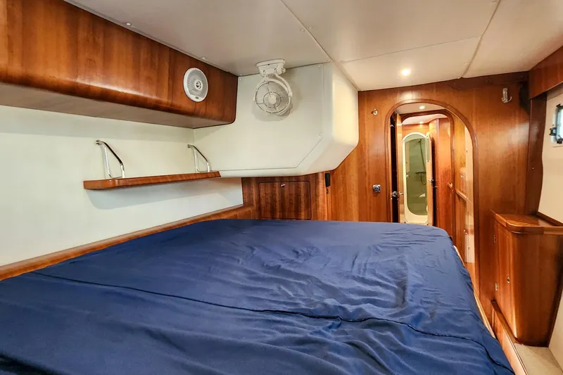 Slide: The Image of Interior cabin of 2007 Antares Catamarans PDQ 44i with wooden finish and blue bedding. - 31