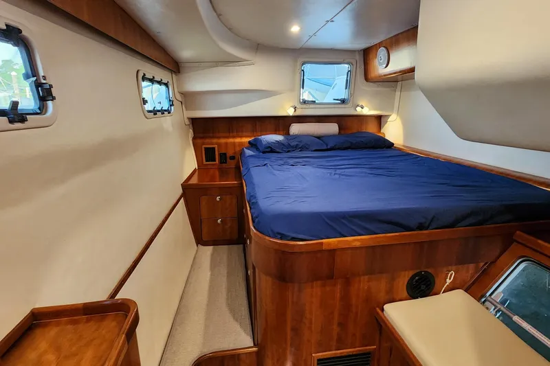 Slide: The Image of Luxurious cabin interior of 2007 Antares Catamarans PDQ 44i with wood finish and cozy bed. - 32