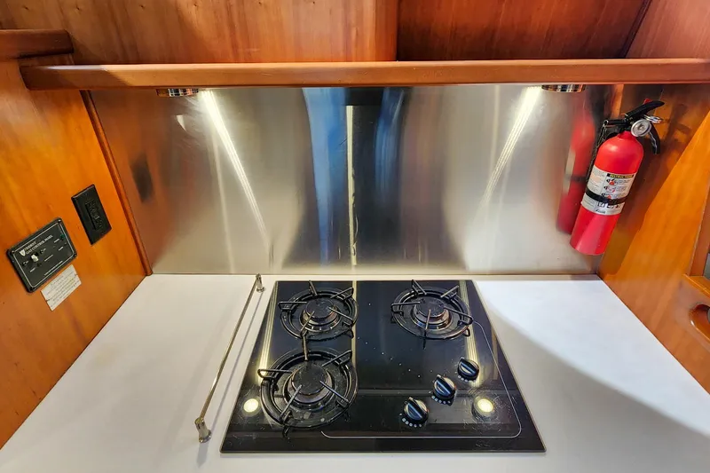 Slide: The Image of Modern kitchen in 2007 Antares Catamarans PDQ 44i with stove and fire extinguisher. - 34