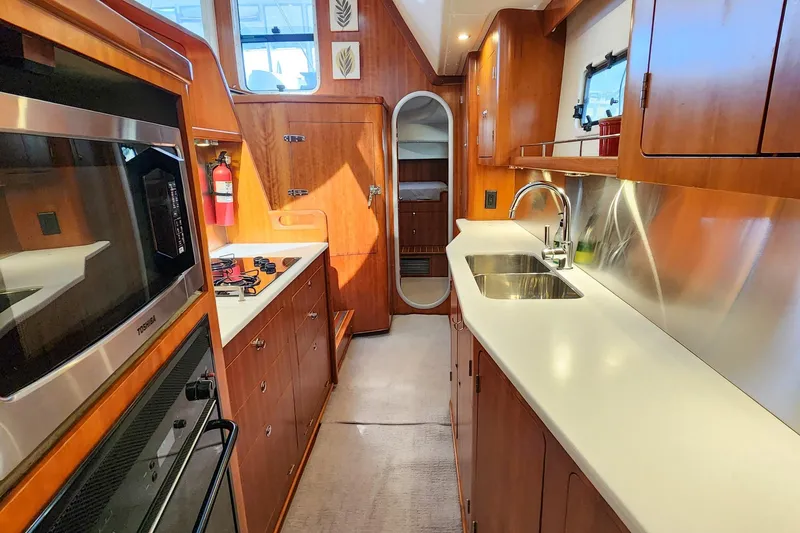 Slide: The Image of Luxurious 2007 Antares Catamarans PDQ 44i galley with modern appliances and sleek wood finish. - 37