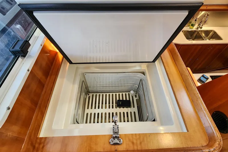 Slide: The Image of Open refrigerator in 2007 Antares Catamarans PDQ 44i, showcasing interior storage space. - 40