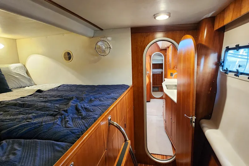 Slide: The Image of Luxurious 2007 Antares Catamarans PDQ 44i cabin interior with cozy bed and wooden finishes. - 43