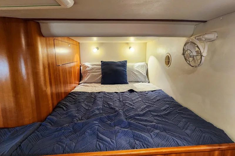 Slide: The Image of Cozy cabin interior of 2007 Antares Catamarans PDQ 44i with blue bedding and wooden accents. - 44