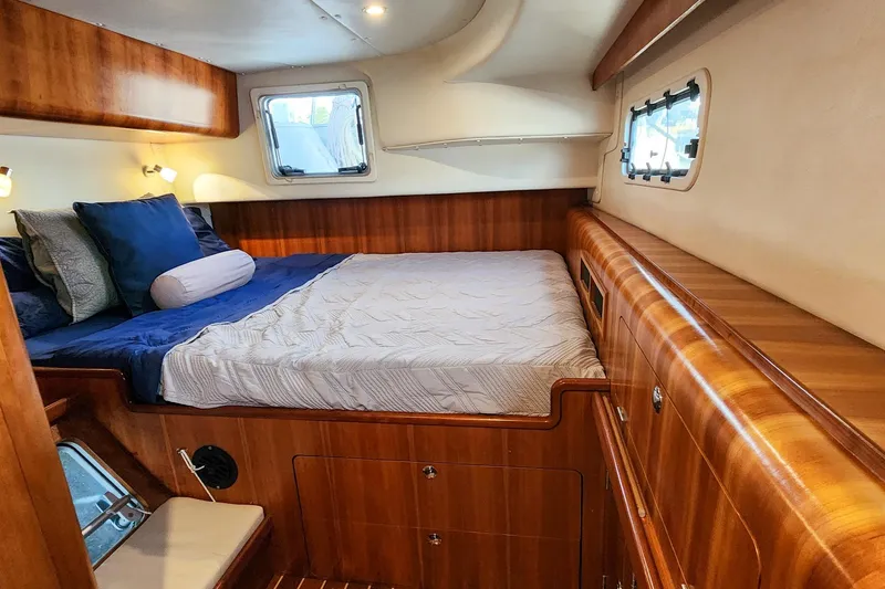 Slide: The Image of Luxurious 2007 Antares Catamarans PDQ 44i cabin with wood finish and cozy bedding. - 45