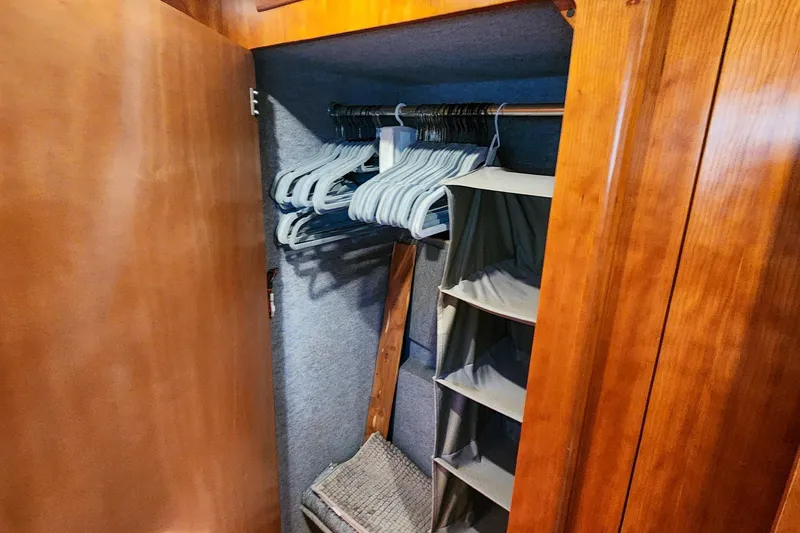 Slide: The Image of Wooden closet interior with hangers and shelves on a 2007 Antares Catamarans PDQ 44i. - 46