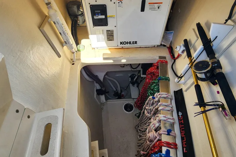 Slide: The Image of Engine compartment of 2007 Antares Catamarans PDQ 44i with Kohler generator and fishing gear. - 47