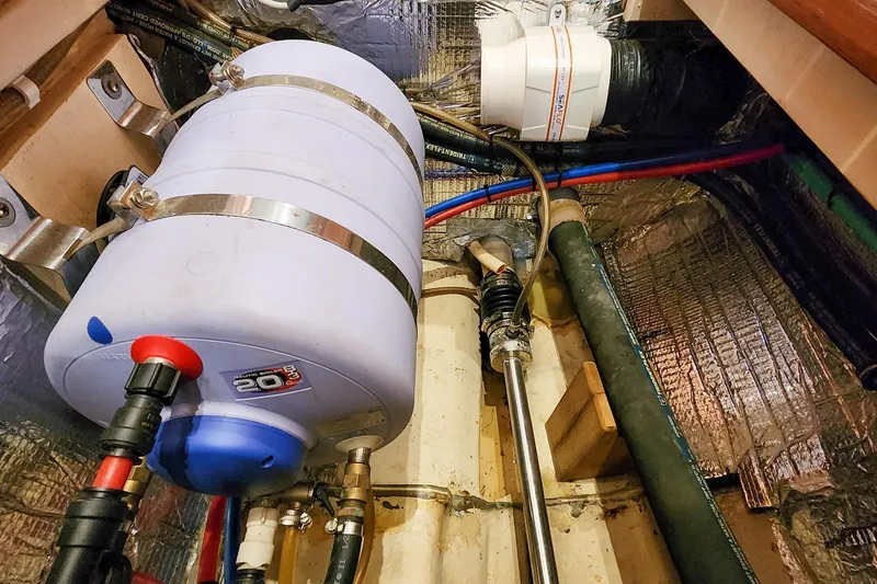 Slide: The Image of Engine room of 2007 Antares Catamarans PDQ 44i, featuring plumbing and insulation. - 54