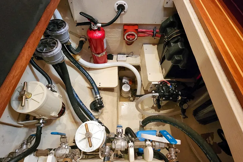 Slide: The Image of Engine room of 2007 Antares Catamarans PDQ 44i with fire extinguisher and plumbing components. - 56