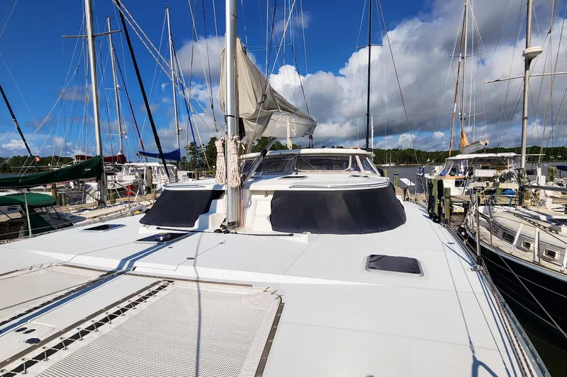 Slide: The Image of 2007 Antares Catamarans PDQ 44i docked, showcasing sleek design and spacious deck. - 9