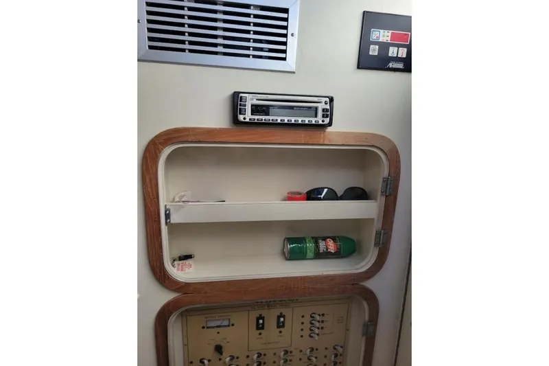 Slide: The Image of 1996 Phoenix 34 Tournament interior with shelf, stereo, and control panel. - 15