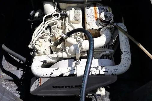 Slide: The Image of Engine of a 1996 Phoenix 34 Tournament boat, featuring a Kohler generator. - 17