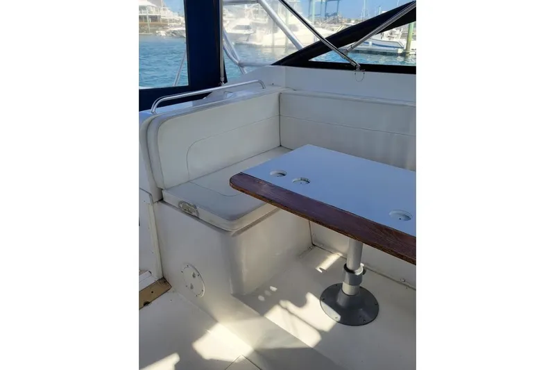Slide: The Image of Interior seating area of 1996 Phoenix 34 Tournament boat with table and window view. - 19