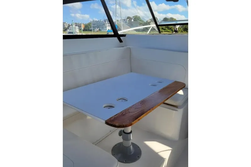 Slide: The Image of Interior of 1996 Phoenix 34 Tournament boat with table and seating area. - 20