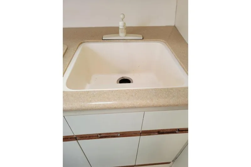 Slide: The Image of Cream-colored sink with countertop in a 1996 Phoenix 34 Tournament boat. - 29