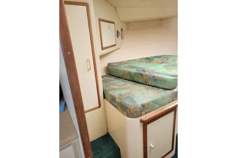 Slide: The Image of 1996 Phoenix 34 Tournament cabin interior with patterned cushions and wooden accents. - 30