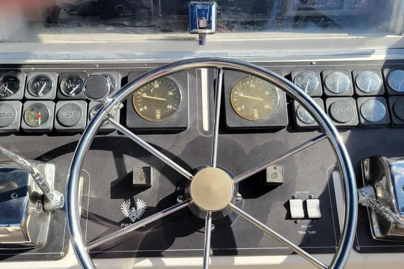 Slide: The Image of 1996 Phoenix 34 Tournament boat dashboard with steering wheel and gauges. - 31