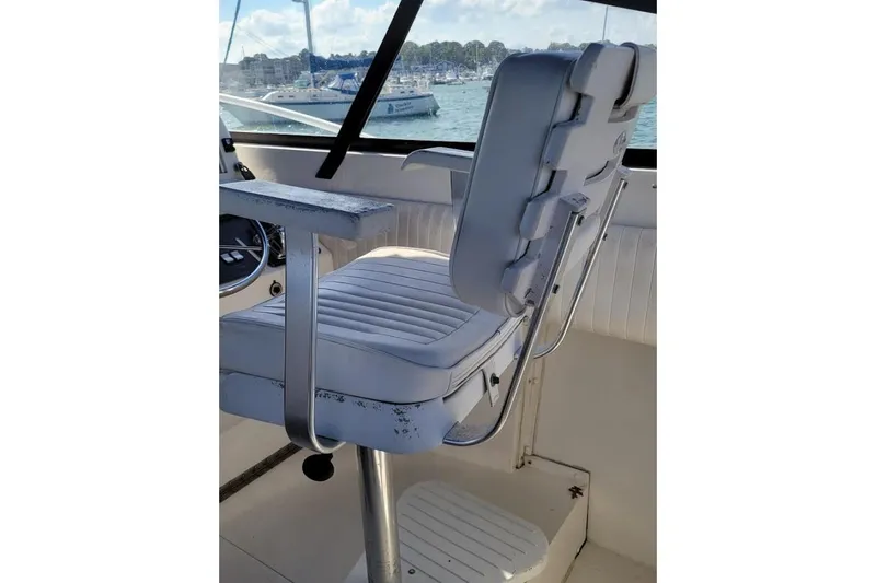 Slide: The Image of Captain's chair on 1996 Phoenix 34 Tournament boat, overlooking marina. - 32