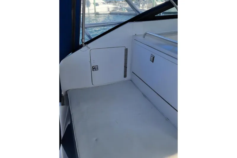 Slide: The Image of Interior view of a 1996 Phoenix 34 Tournament boat, featuring seating and storage. - 34