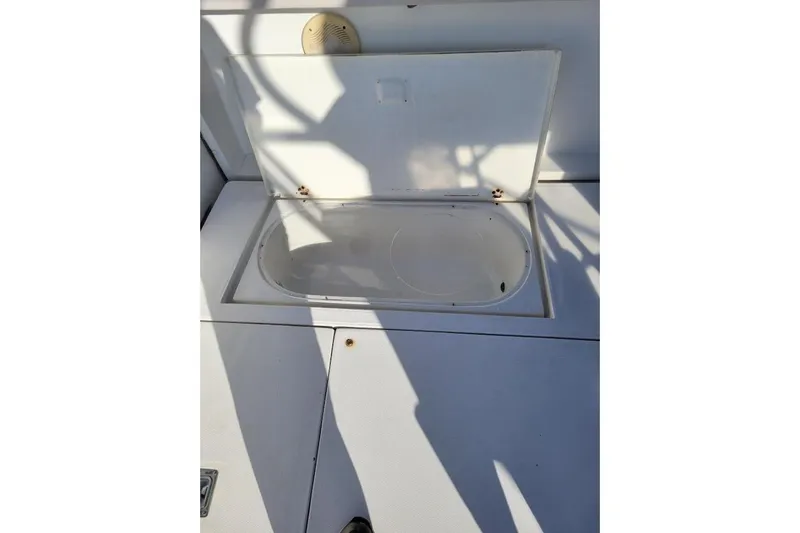 Slide: The Image of Open storage compartment on 1996 Phoenix 34 Tournament boat deck. - 35