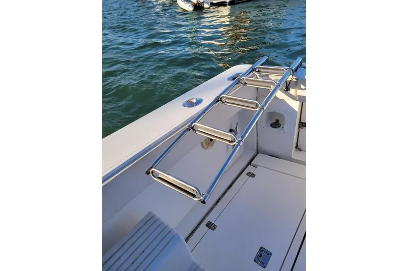 Slide: The Image of Stainless steel ladder on 1996 Phoenix 34 Tournament boat, docked on water. - 39