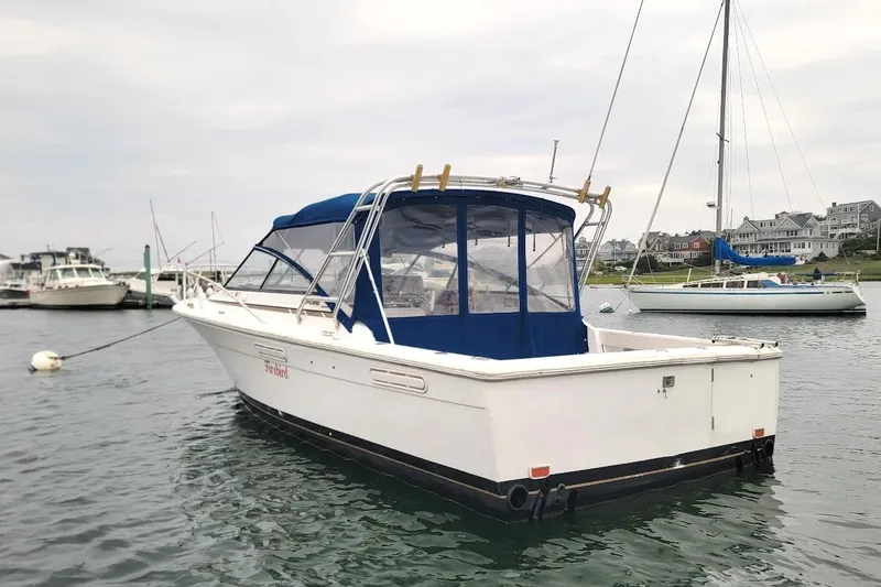 Slide: The Image of 1996 Phoenix 34 Tournament boat docked in a marina with sailboats nearby. - 40