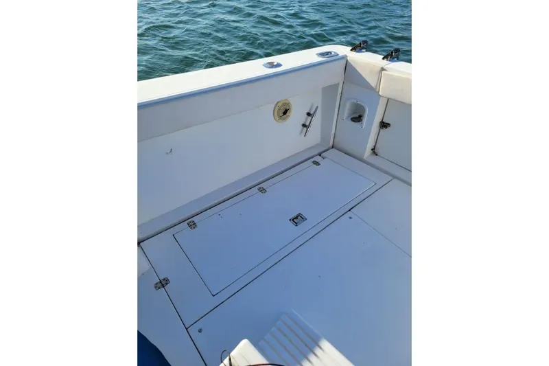 Slide: The Image of 1996 Phoenix 34 Tournament boat deck with storage compartments, on calm water. - 41