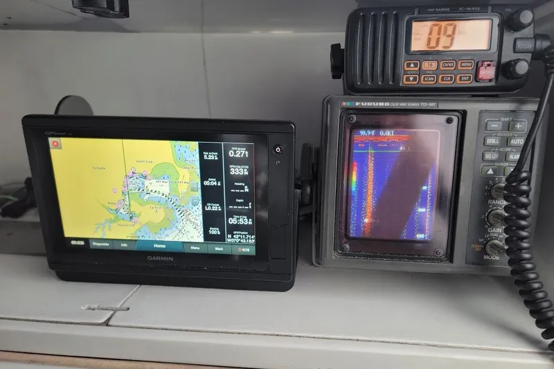 Slide: The Image of Boat navigation equipment on a 1996 Phoenix 34 Tournament, featuring Garmin and Furuno displays. - 6