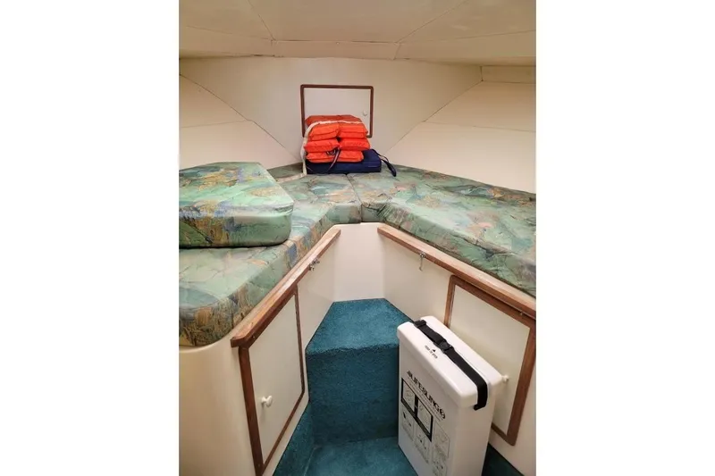Slide: The Image of Interior cabin of 1996 Phoenix 34 Tournament boat with cushions and life jackets. - 7