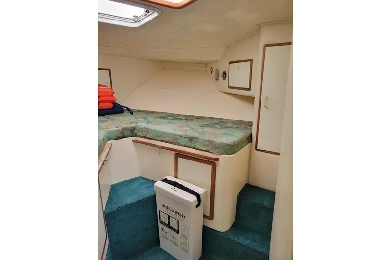 Slide: The Image of Interior cabin of 1996 Phoenix 34 Tournament boat with bed and storage. - 8