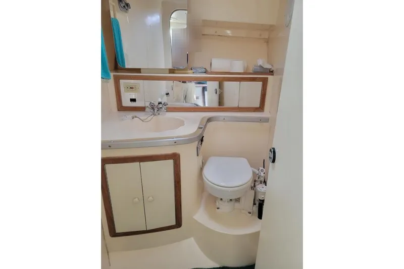 Slide: The Image of Bathroom interior of 1996 Phoenix 34 Tournament boat with sink and toilet. - 9