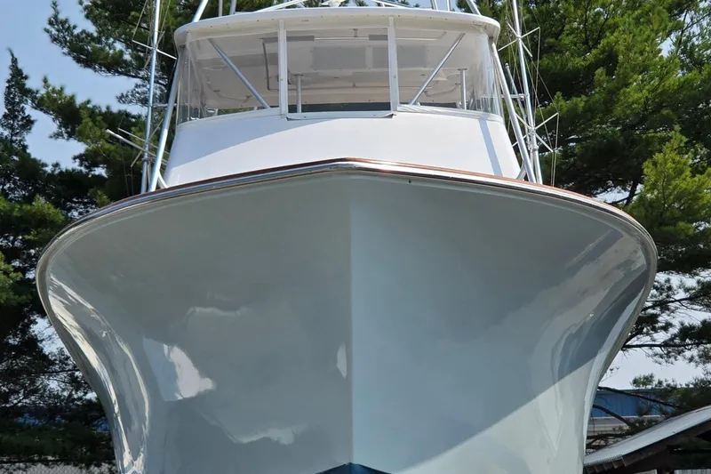 Slide: The Image of 1986 Ocean Yachts 55 Super Sport boat, front view with trees in background. - 10