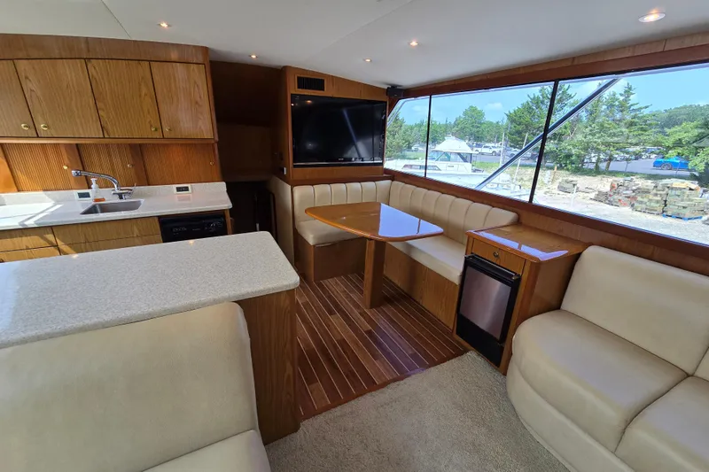 Slide: The Image of Interior of 1986 Ocean Yachts 55 Super Sport with kitchen and seating area. - 13
